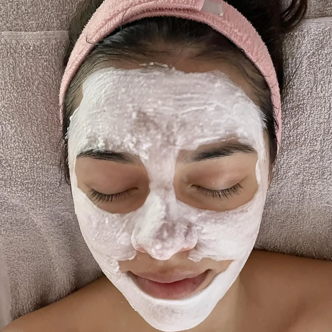 A client with a white treatment mask